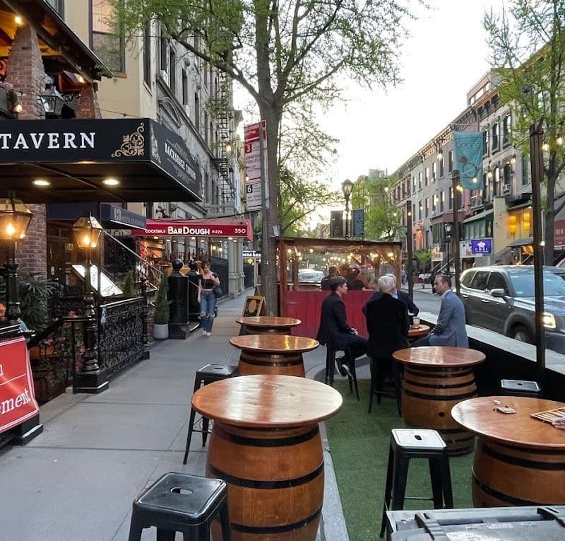 Interior of Backstage Tavern in Times Square with its wood-carved main bar and high ceilings
